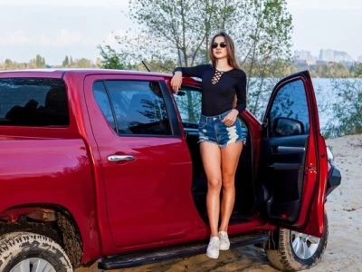 Open door of a red pickup.